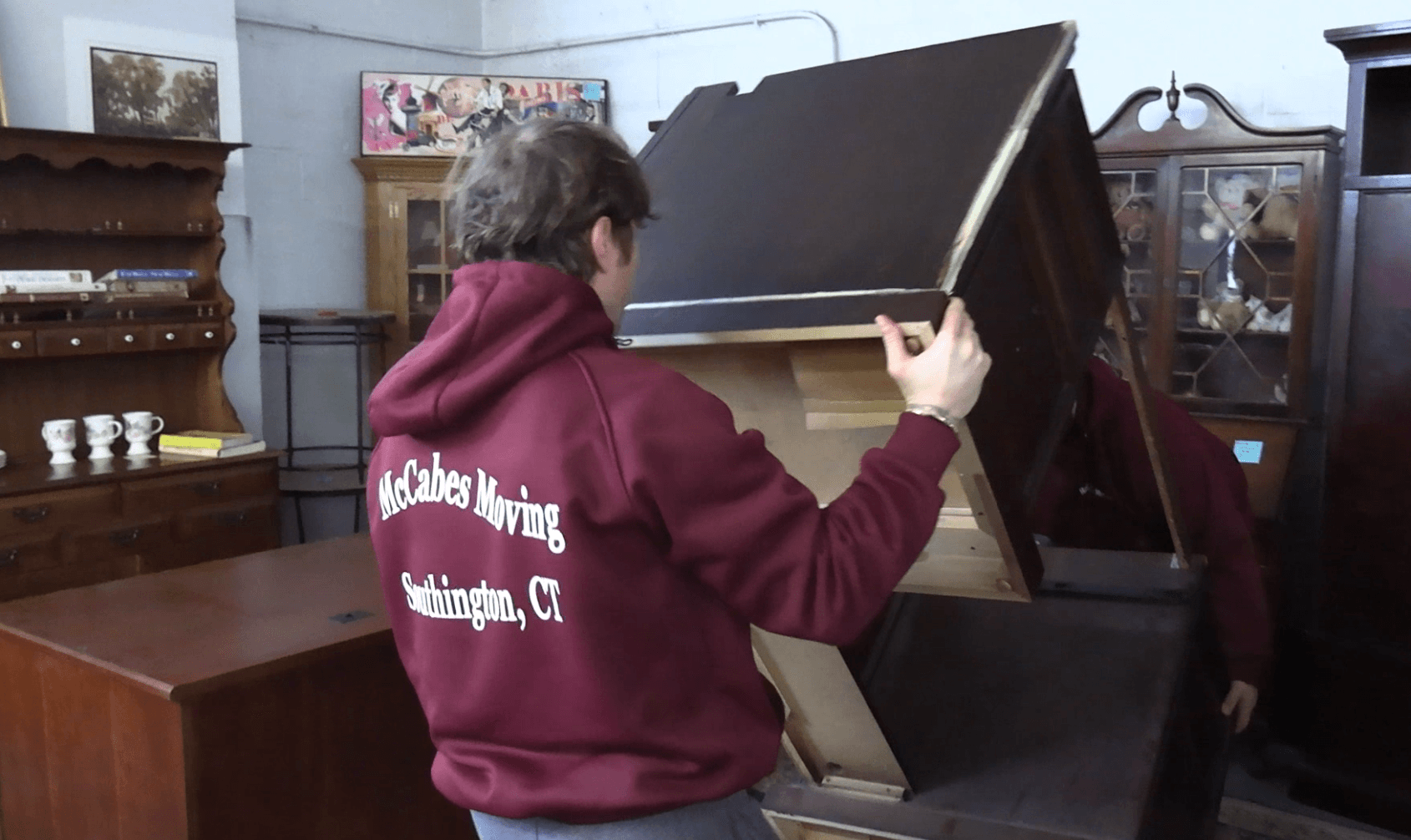 McCabe's Moving crew member moving a large furniture piece